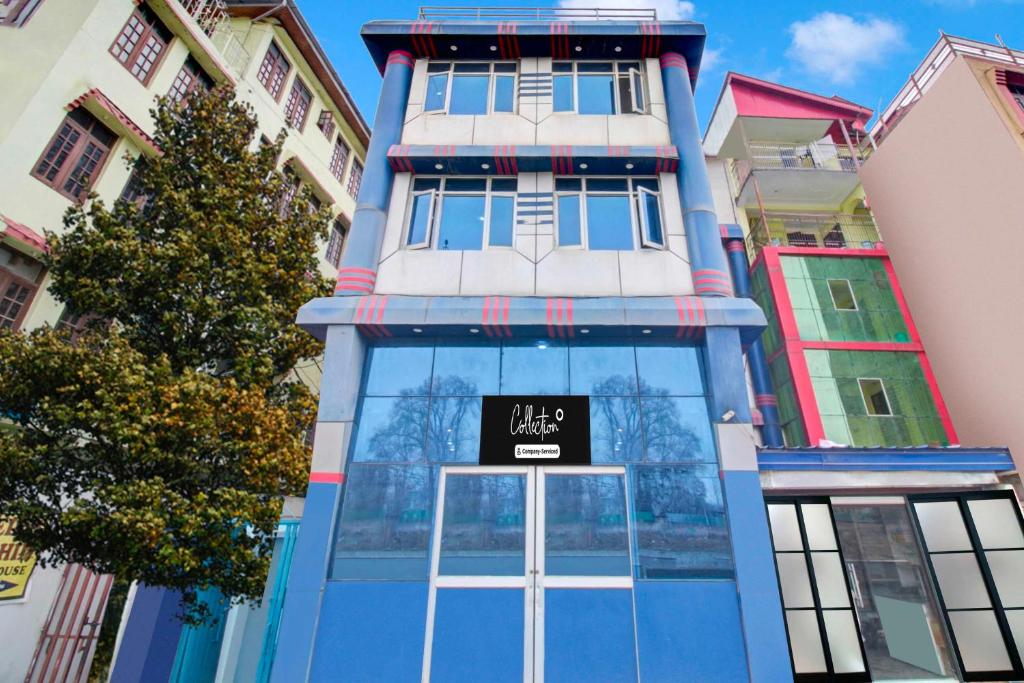 a blue building with a sign in front of it at Collection O Srinagar Jhelum Riverside in Srinagar