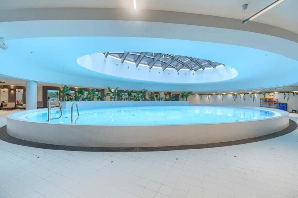 a large tub in the middle of a building at FRANKO APARTAMENTS - Hanza Tower in Szczecin