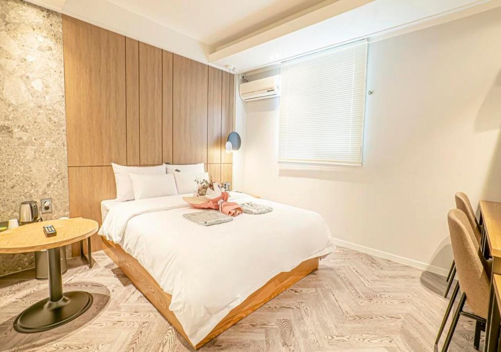 a bedroom with a bed with a laptop on it at No25 Doksan Intersection in Seoul