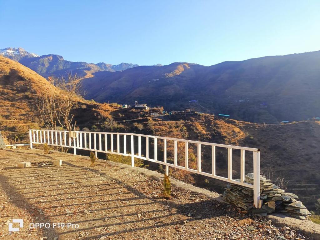 a white fence on the side of a mountain at The Holiday Resort in Kailāna