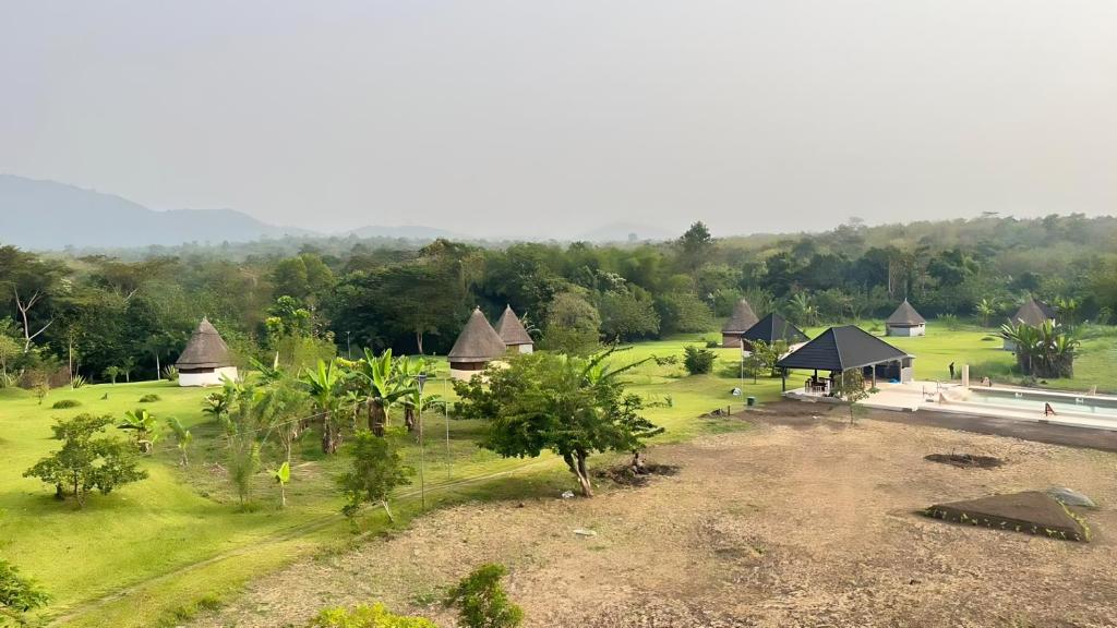 an aerial view of a resort with a field and trees at REFUGE du MONT AGOU in Liatonou