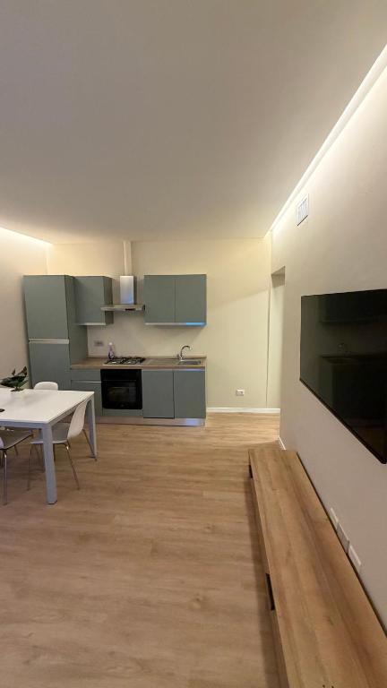 a living room with a table and a kitchen at Milan house 2 in Samarate