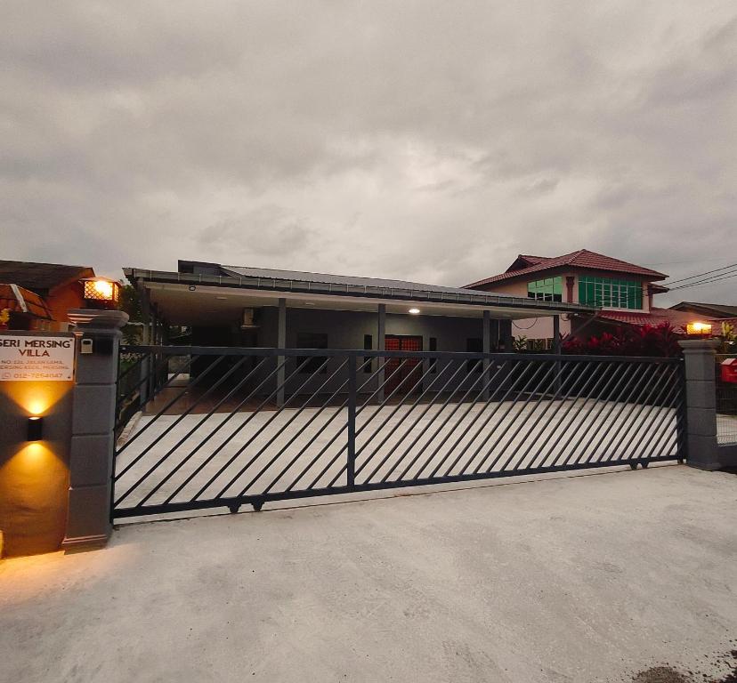 a gate in front of a house with a fence at Seri Mersing Villa A in Mersing