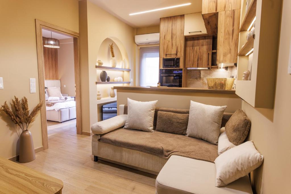 a living room with a couch and a kitchen at Asana luxury apartment in Kozani