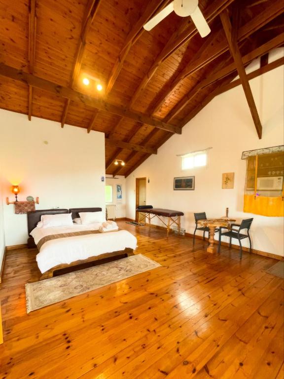 a bedroom with a bed and a wooden ceiling at Nof Harim נוף הרים in Even Menahem