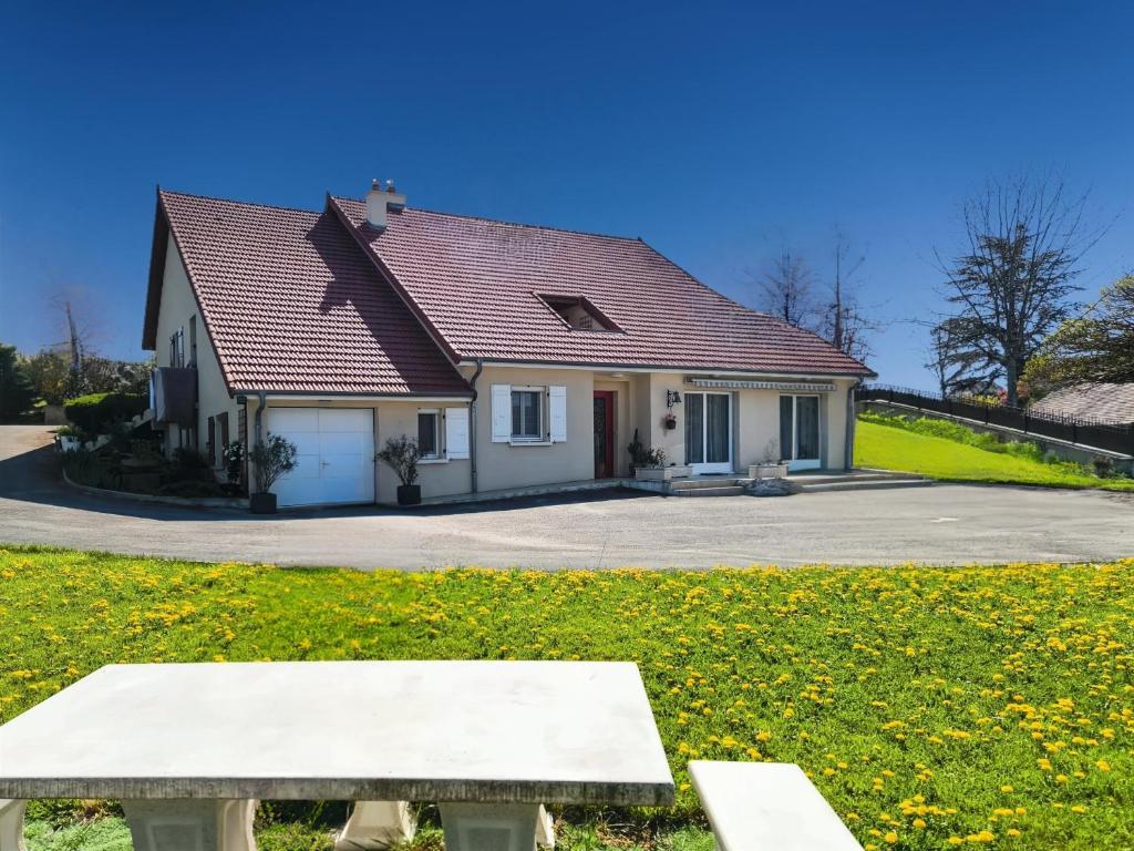 a house with a bench in front of it at Les Bergeronnettes in Trénal