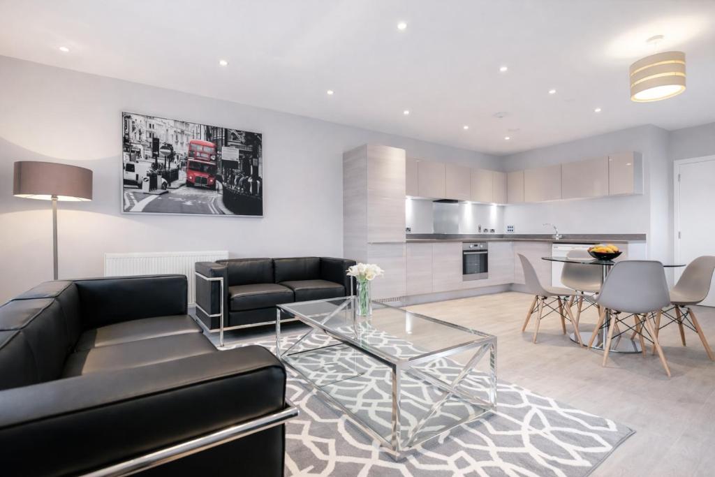 a living room with a couch and a table at Roomspace Serviced Apartments - Vertex House in Croydon