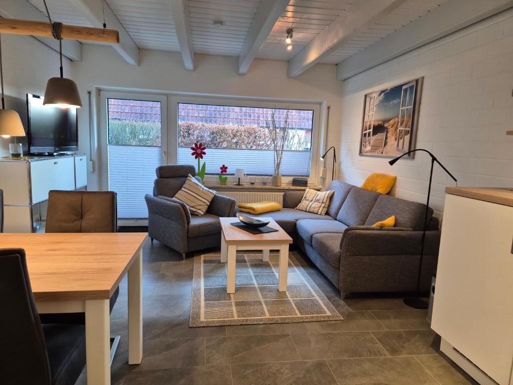 a living room with a couch and a table at Zauberhaus in Norddeich