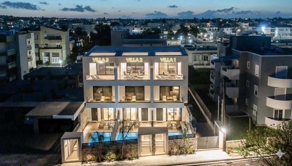 an apartment building in a city at night at Lacha Houses Villas in Kos