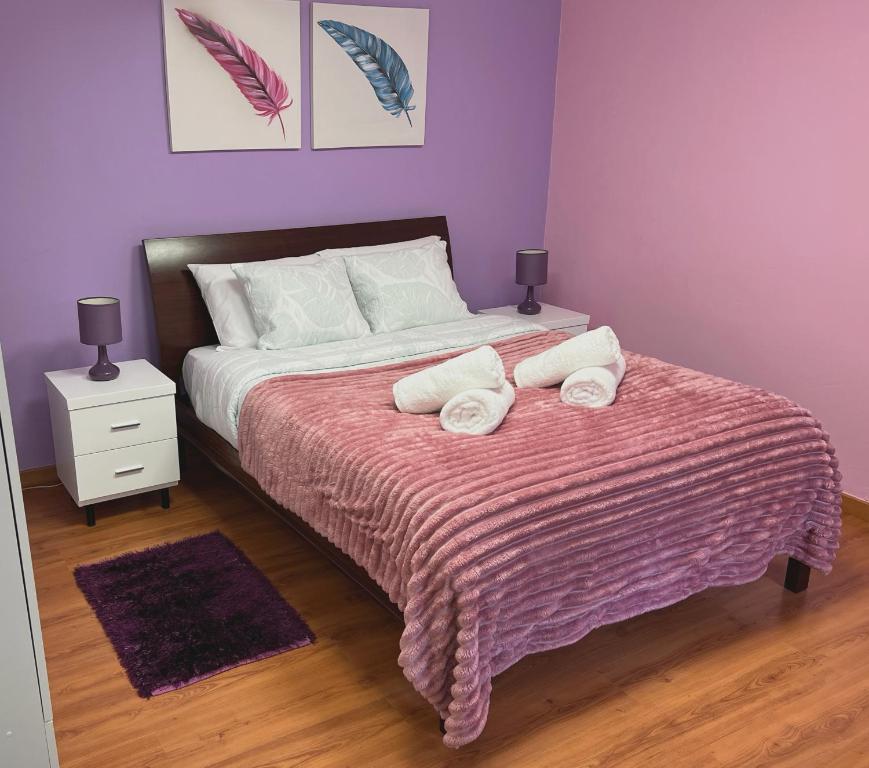 a bedroom with a bed with two towels on it at Casa Levada Explorer - Cozy Nights & Easy Meals in Santana