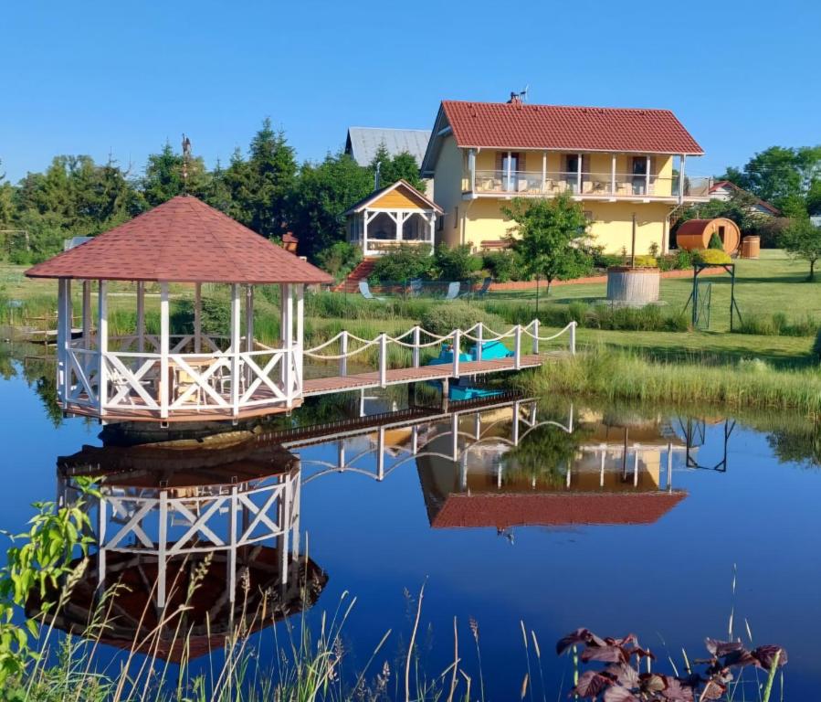 a house on a pond with a gazebo at Dolina Miodu - Agro Kaszuby, Sauna, Balia in Borowina