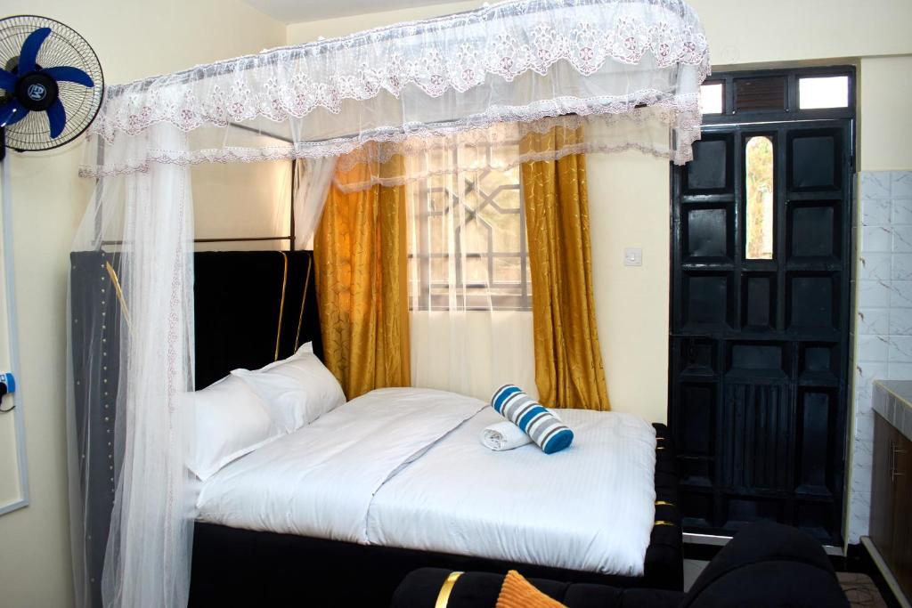 a bedroom with a bed with a canopy at Deluxe Homes 2, Voi in Voi