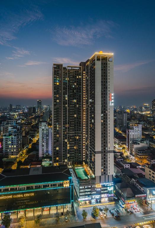 a city skyline at night with a tall building at Intercity Hotel & Serviced Apartment Phnom Penh Downtown in Phnom Penh