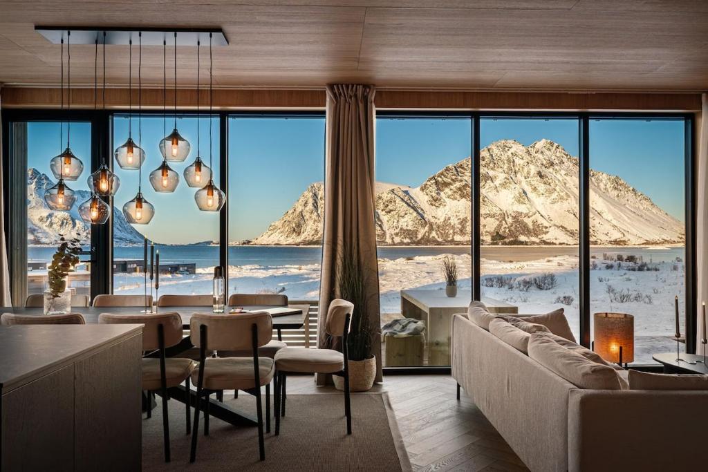a living room with a view of a mountain at Secluded Lodge - Stunning Views! in Storøya