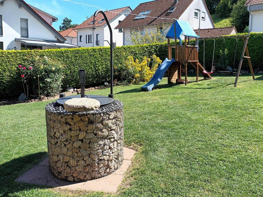 a park with a playground with a tree stump at Haus Petra in Gleishorbach