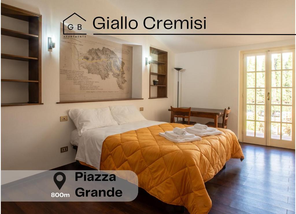 a bedroom with a bed with a map on the wall at Piazza Grande-Giallo Cremisi in Arezzo
