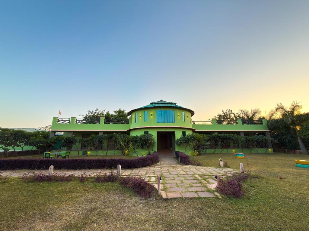 a large green building with a pathway in front of it at GREEN VALLEY SARISKA in Tehla