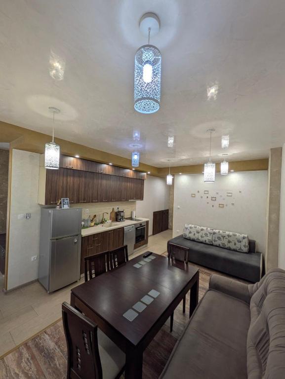 a living room with a table and a kitchen at Наслада in Panagyurishte