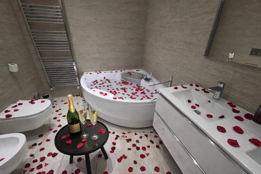 a bathroom with a tub with red hearts on the floor at Centro Storico Suites in Ferrara
