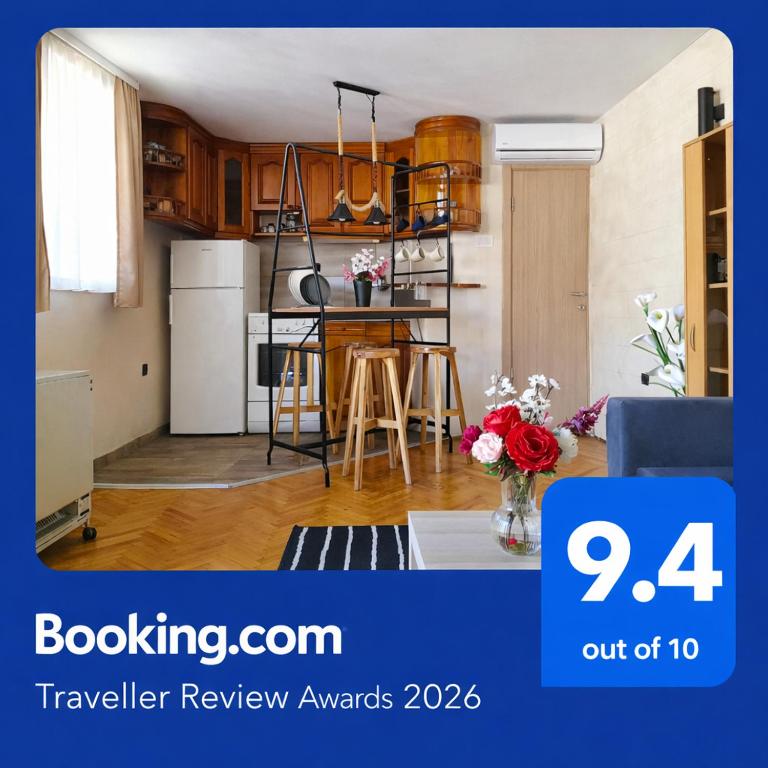 a living room with a kitchen with a table at Apartman AS in Belgrade