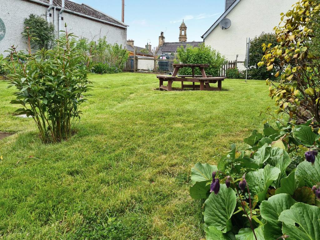 a picnic table sitting in the grass in a yard at Solus Na Madainn in Tain