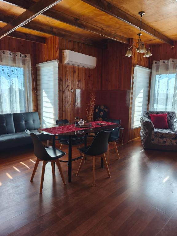 a living room with a table and chairs and a couch at Astilleros,Dalcahue in Dalcahue