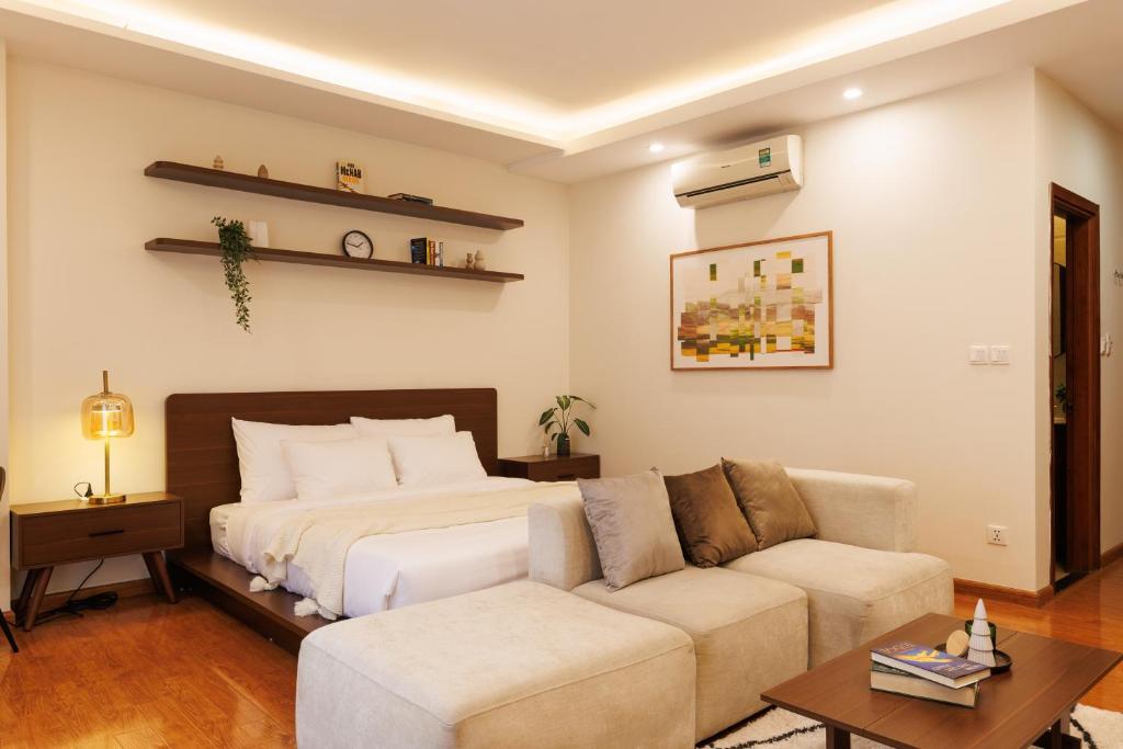 a bedroom with a bed and a couch at Beloved Summer House in Hanoi