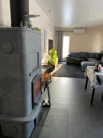 a living room with a fire place in the middle at Villa Naava in Lukkarinsaari