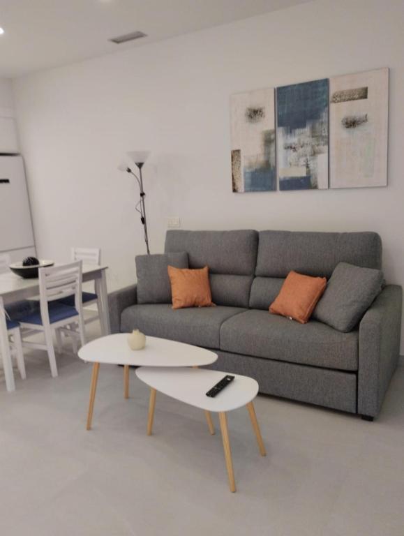 a living room with a couch and a table at Iberflat Apartamentos Alfabega in Paterna