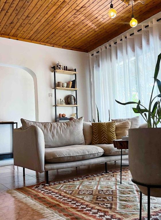 a living room with a couch and a table at The Garden Home in Arusha