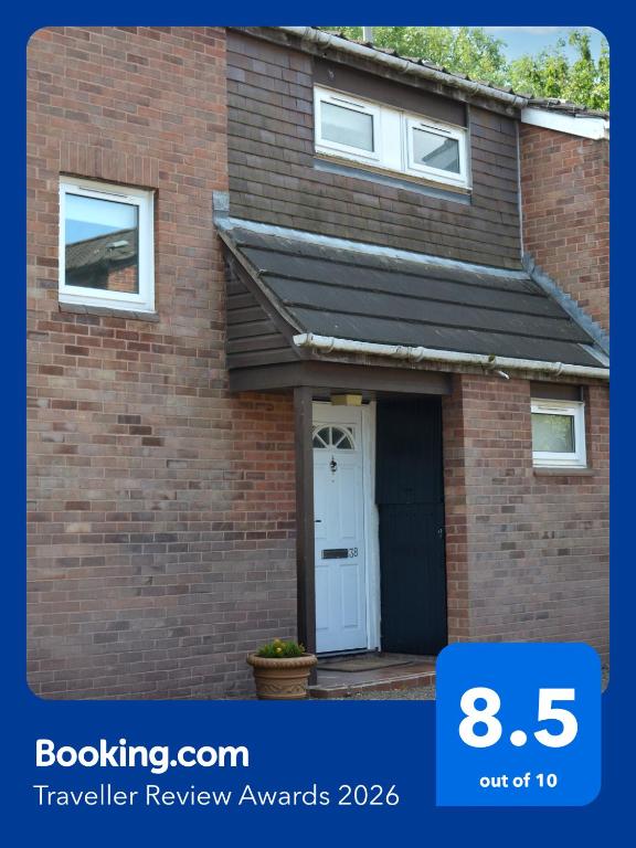 a red brick house with a white door at Large 2 bedroom house in Wombridge