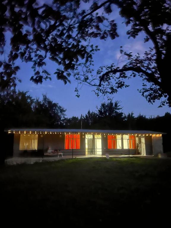 a house lit up at night with christmas lights at Guest House Chalastavi in Godogani