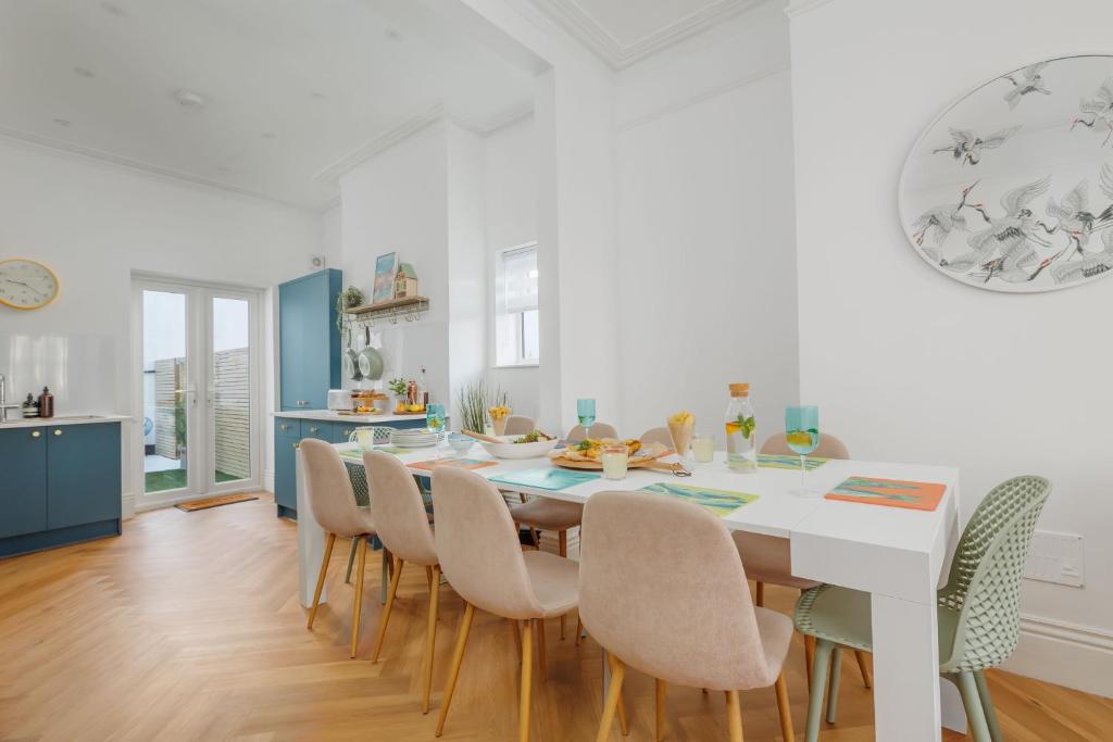 a kitchen and dining room with a table and chairs at Beachway House in Weymouth
