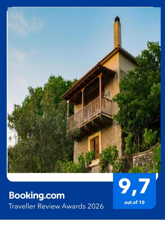 a house with a balcony on top of it at Arcadianis lakeview villa at Psari Arcadias in Psárion