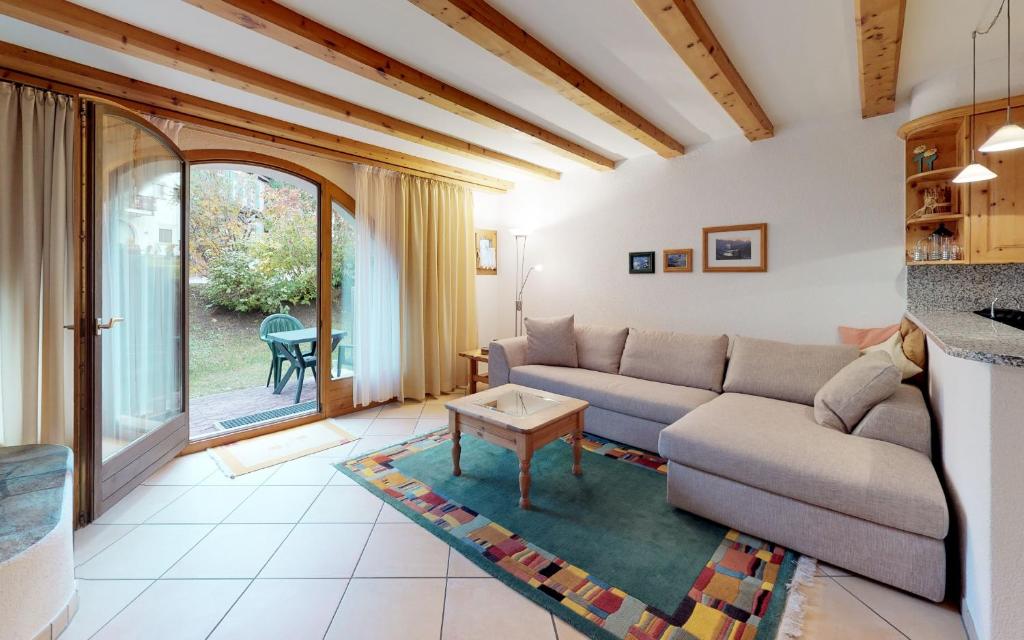 a living room with a couch and a table at Champagna in Celerina