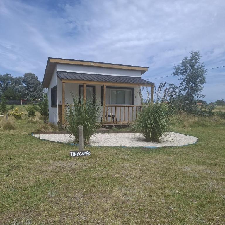 a tiny house with a porch in a field at Tiny House Pura Vida Chapadmalal in Colonia Chapadmalal