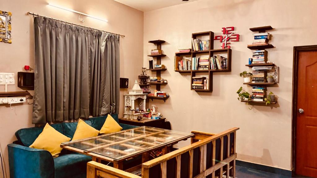 a living room with a couch and a table at GoArize by Rootsvilla Vagator in Anjuna