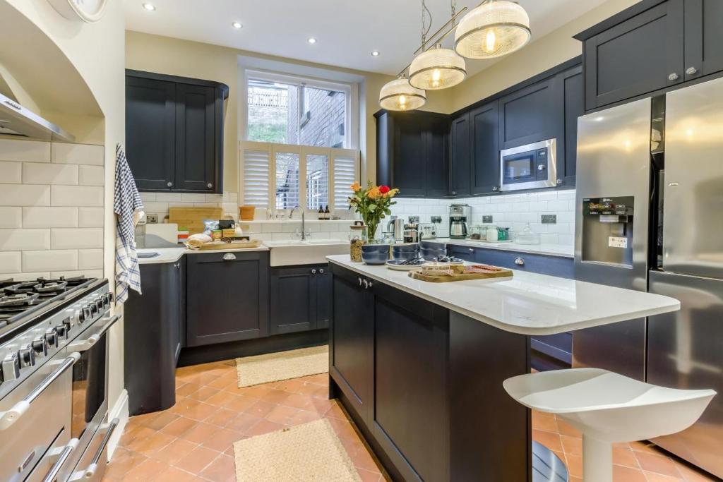 a kitchen with black cabinets and white counter tops at 5 Bed in Llangollen oc-l34205 in Llangollen