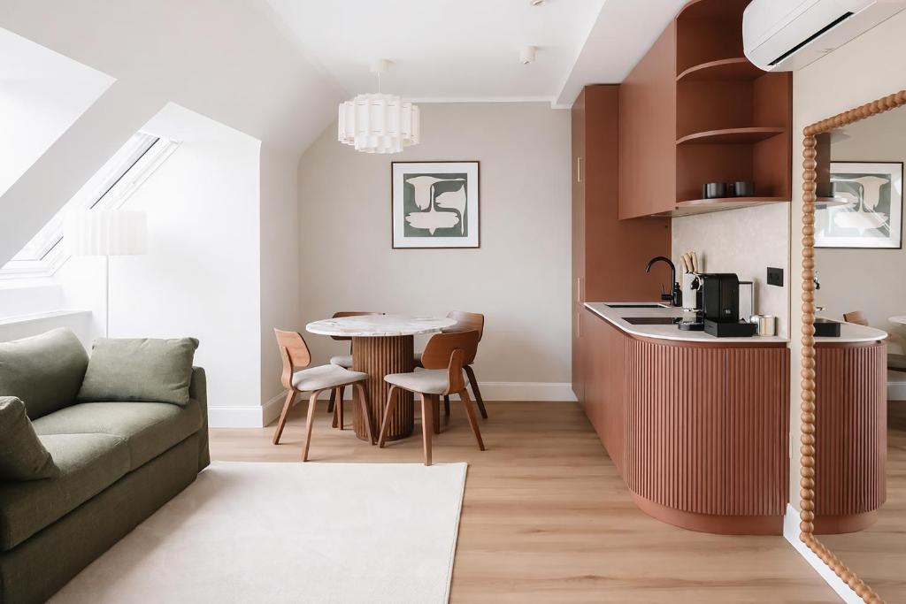a living room with a couch and a table at HeyMi Apartments Brick Lane Vienna in Vienna