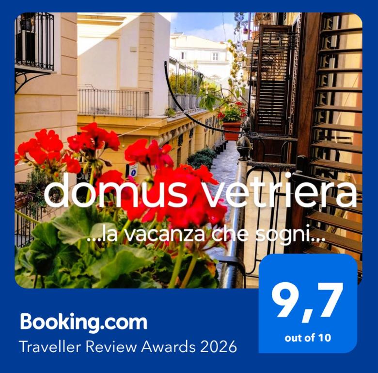 a picture of a street with red flowers at Domus Vetriera in Palermo