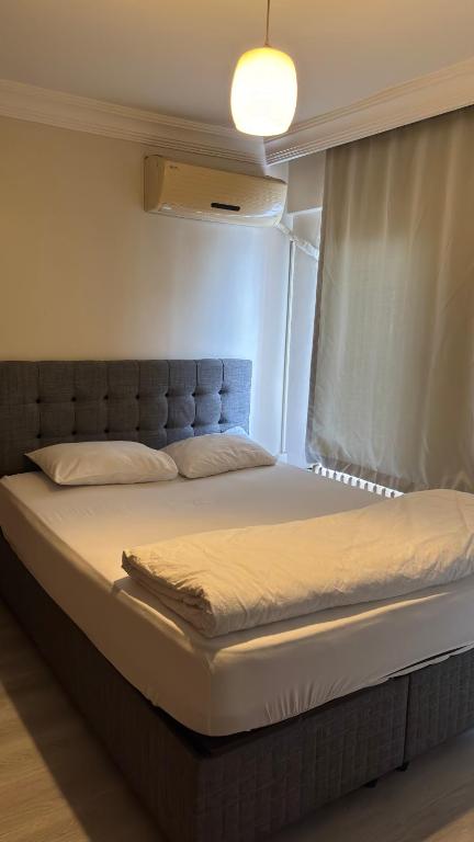 a large bed in a room with a window at Huzur Otel Ümraniye in Istanbul