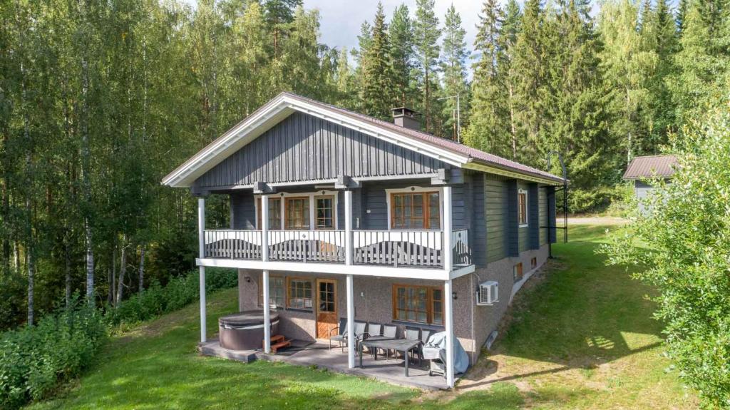 a small house with a porch and a balcony at Himospeili in Jämsä