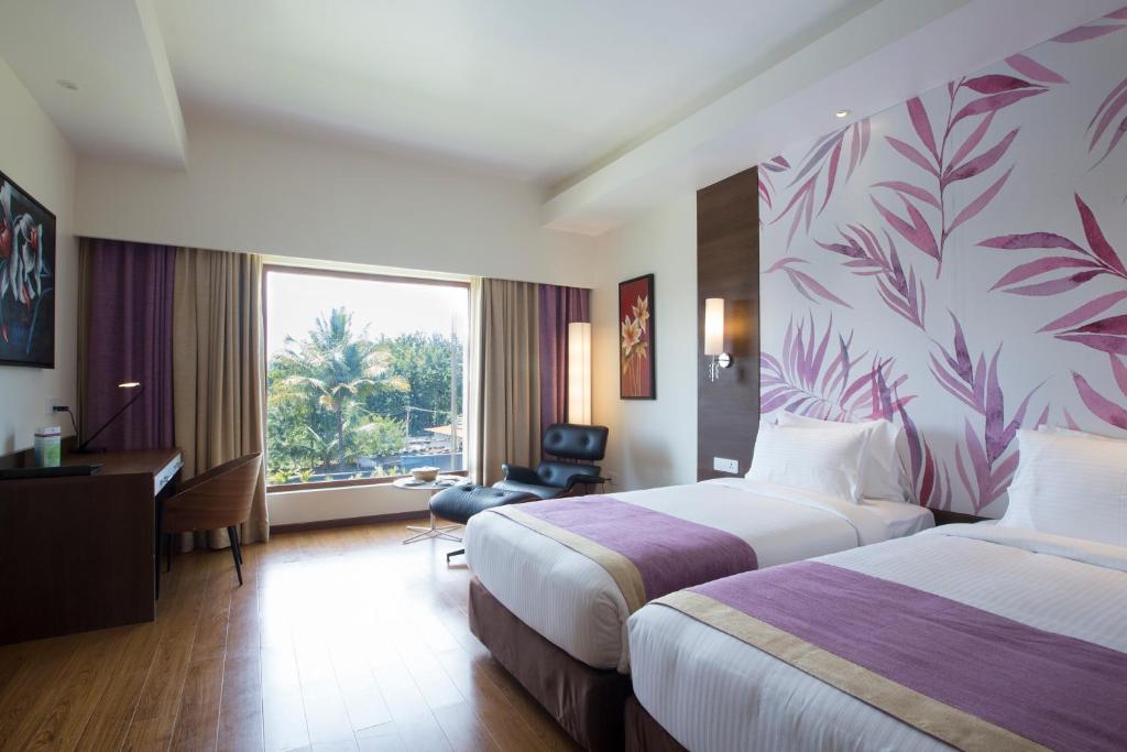 Postel nebo postele na pokoji v ubytování Purple Palms Resort & Spa