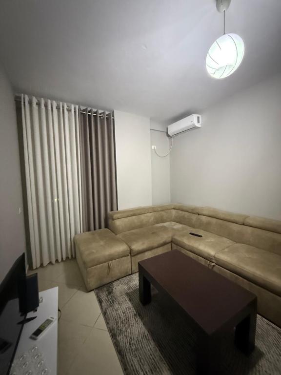 a living room with a couch and a coffee table at Ferit's Property Near Astir in Tirana