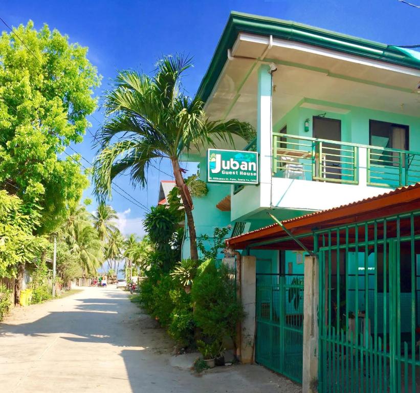 a building with a sign on the side of it at Juban Guest House in Pooc