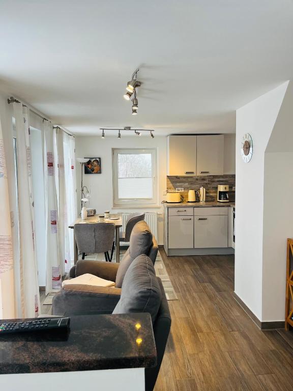 a living room with a couch and a kitchen at Lieblingsplatz in Kappeln