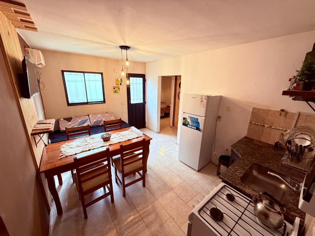 a kitchen and dining room with a table and a refrigerator at Tucuman 890 in Villa María