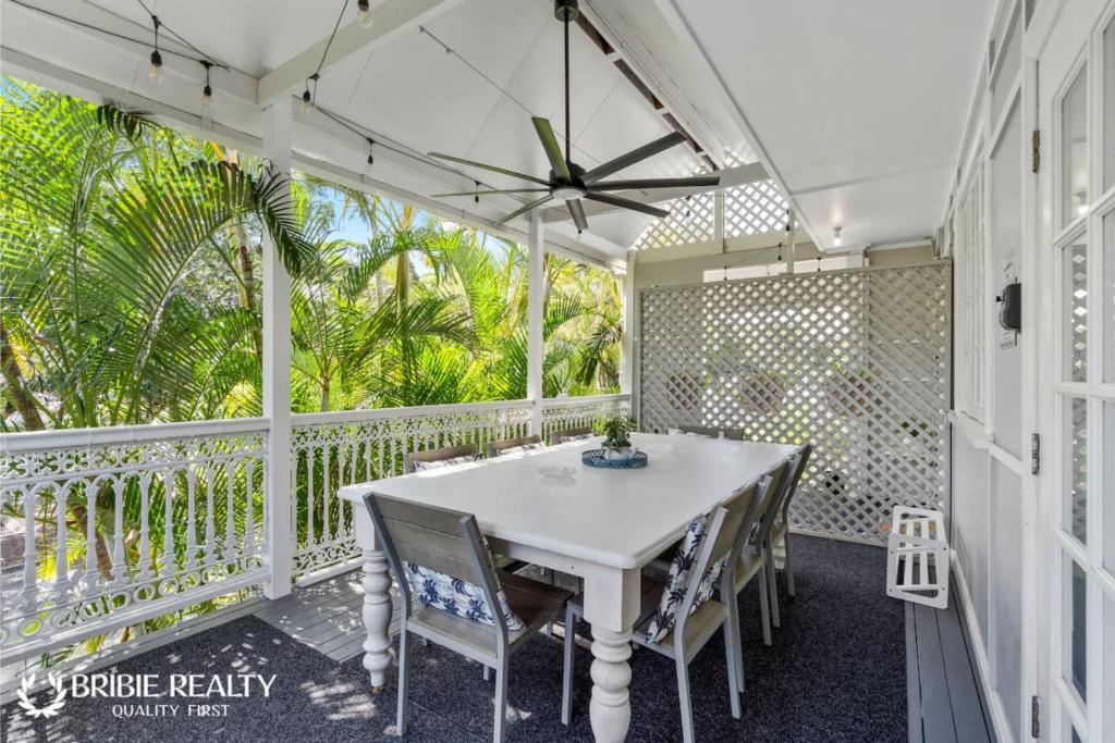 a white porch with a table and chairs on it at BELLA ABODE AND POOL 4 Bedroom Entertainer in Bongaree