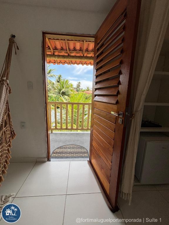 an open door with a view of a balcony at Suites Fernandes Fortim in Fortim