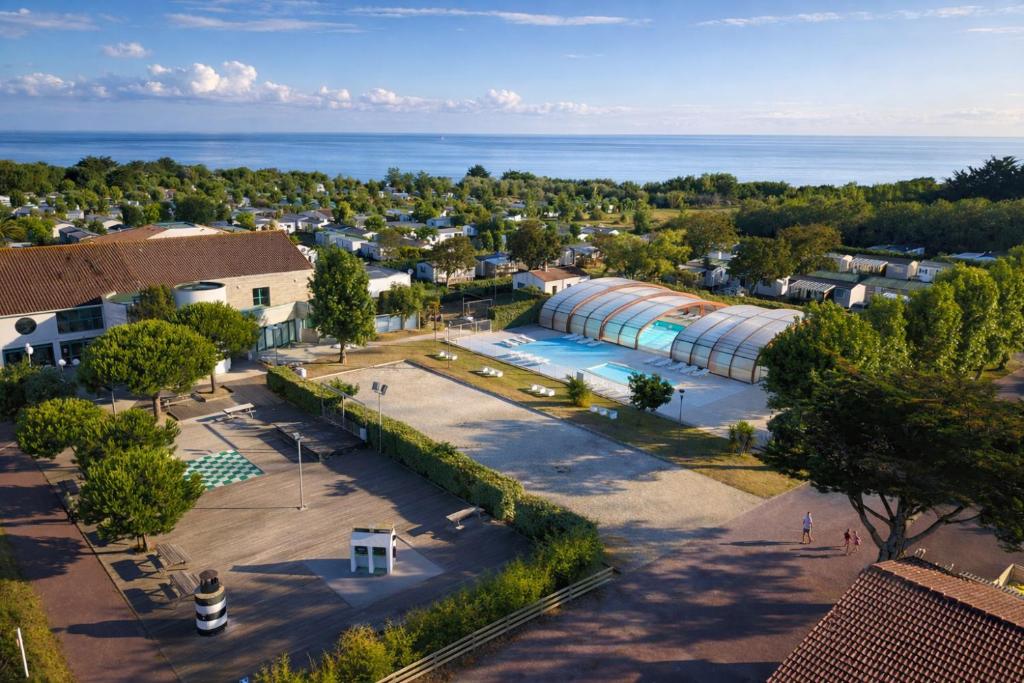 an aerial view of a resort with a swimming pool at ULVF Les Beaupins in Saint-Denis-dʼOléron